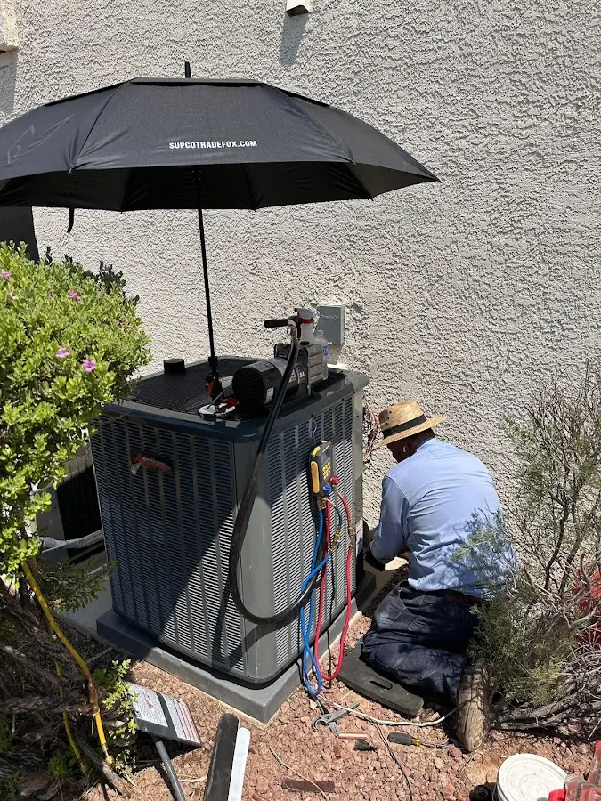 HVAC technician performing outdoor AC maintenance in Groveport